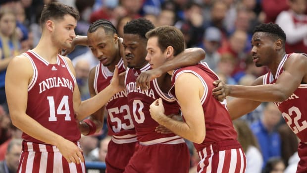Indiana super-senior Xavier Johnson (0) is helped off the court after an injury during the first half of Saturday's game inside Allen Fieldhouse.